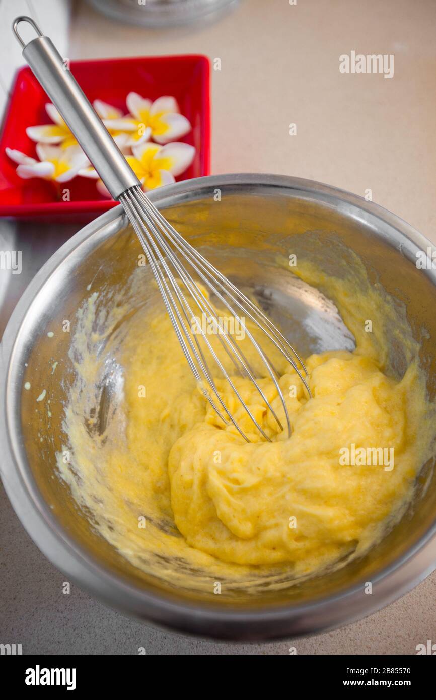 Whipping yellow cream with a whisk close up Stock Photo