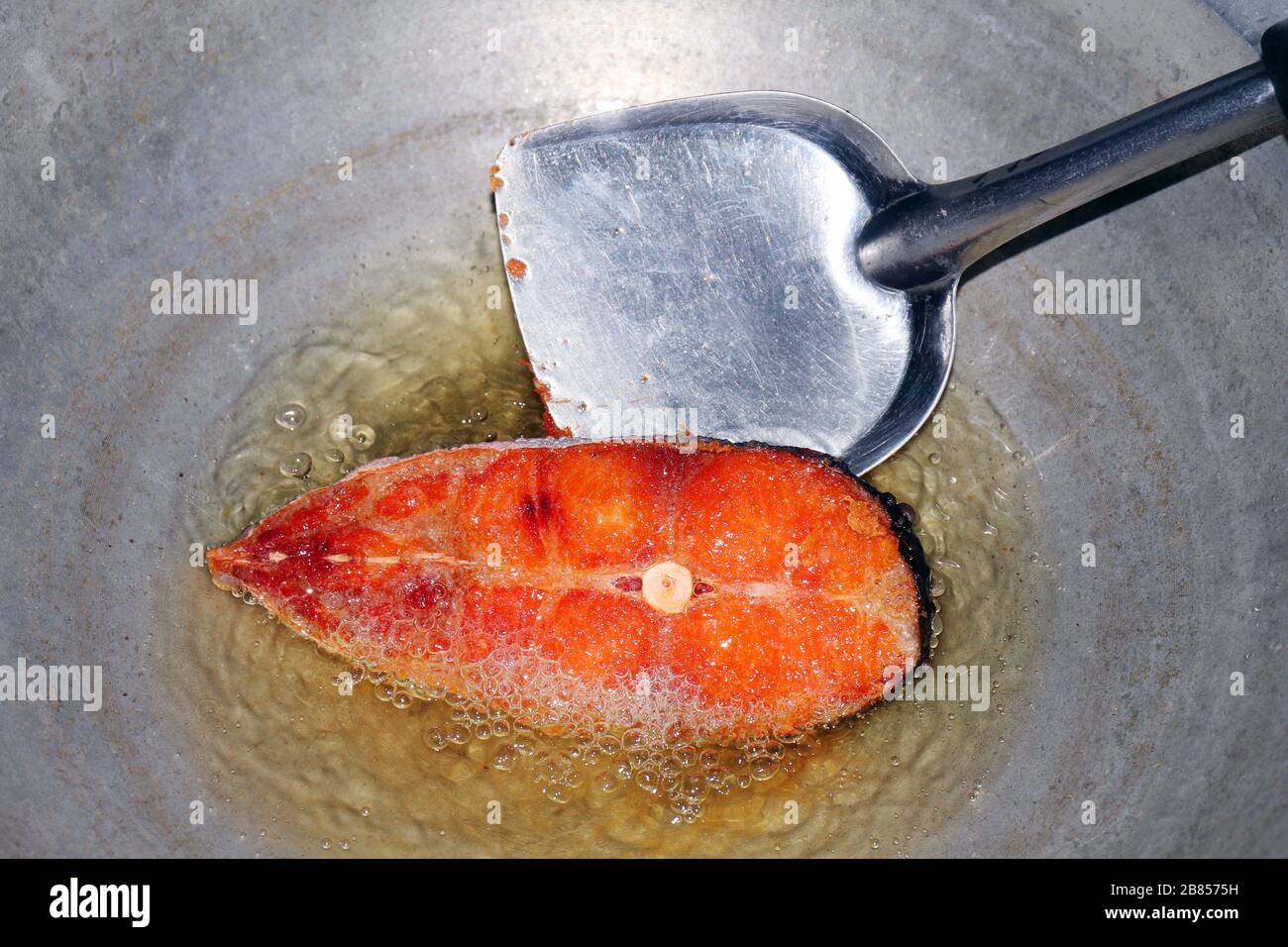 Fried fish pieces in hot oil pan, Fried fish for diet, Fish cutting