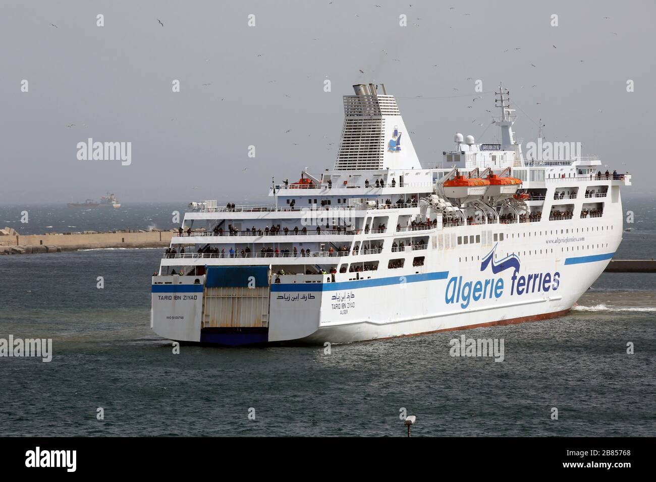 Algiers. 19th Mar, 2020. A ship carrying Algerians from France arrives in Algiers, Algeria, on March 19, 2020. Algerian government said the passengers will be sent to several hotels for medical examinations and then all will be quarantined for 14 days before returning to their hometowns. Credit: Xinhua/Alamy Live News Stock Photo