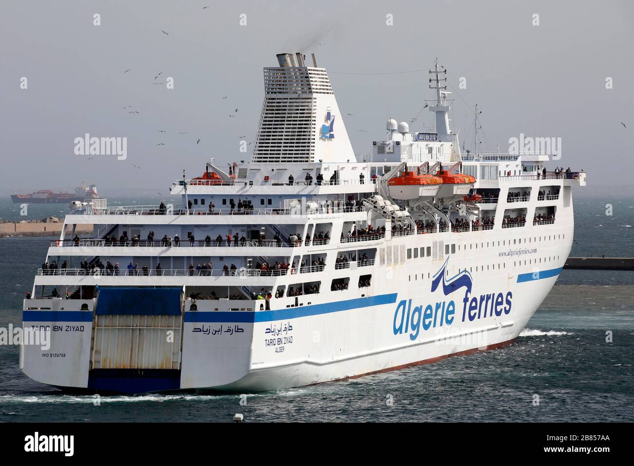 Algiers. 19th Mar, 2020. A ship carrying Algerians from France arrives in Algiers, Algeria, on March 19, 2020. Algerian government said the passengers will be sent to several hotels for medical examinations and then all will be quarantined for 14 days before returning to their hometowns. Credit: Xinhua/Alamy Live News Stock Photo