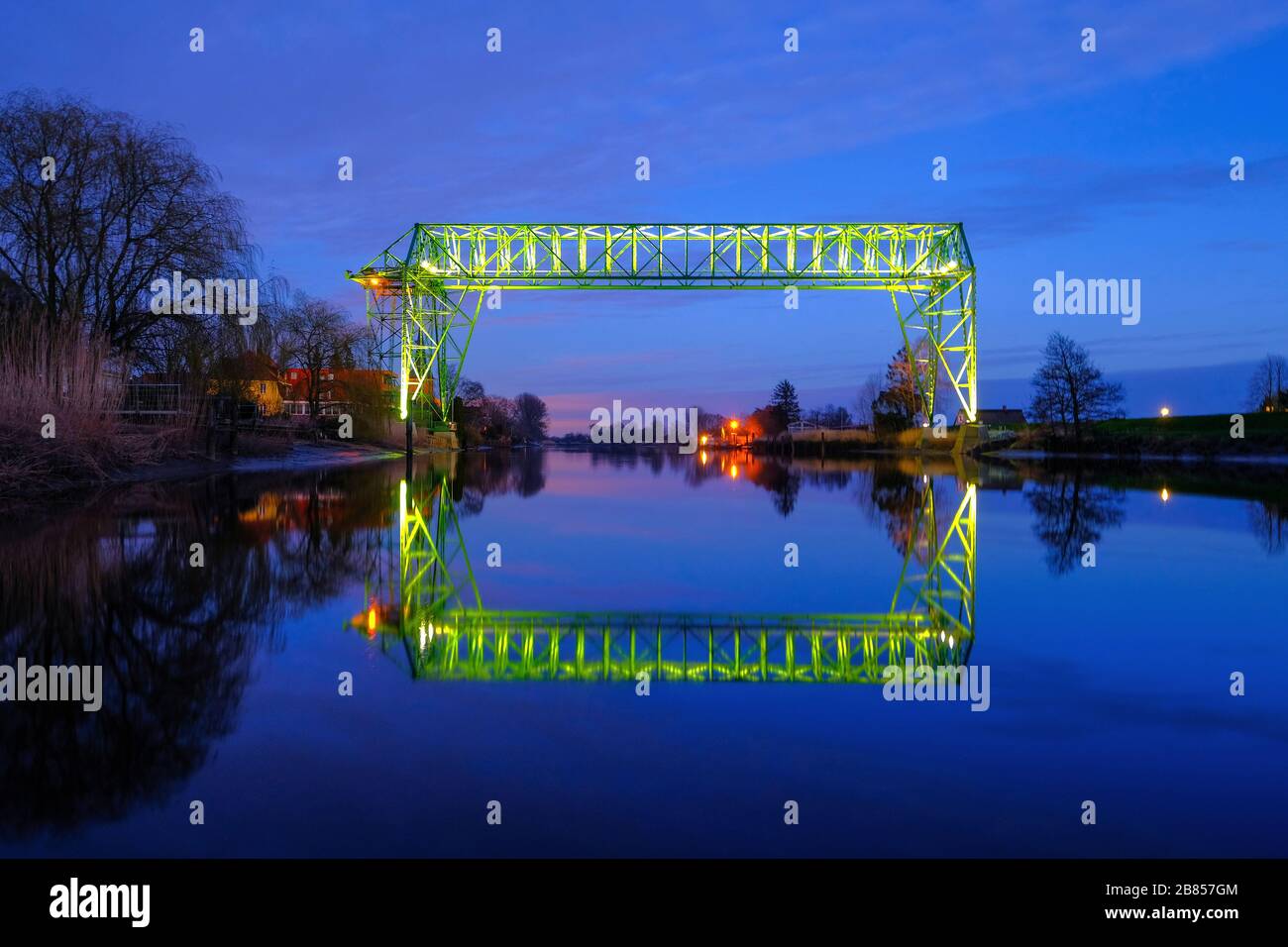 Osten Hemmoor, Germany. 19th Mar, 2020. The photo shows the 111-year-old floating ferry in Hemmoor-Ost, illuminated at night. The ferry transports visitors with a gondola from the municipality of Osten across the river Osten to the town of Hemmoor. (To dpa: 'Floating ferry attracts visitors from all over the world: start of season postponed') Credit: Patrik Stollarz/dpa/Alamy Live News Stock Photo