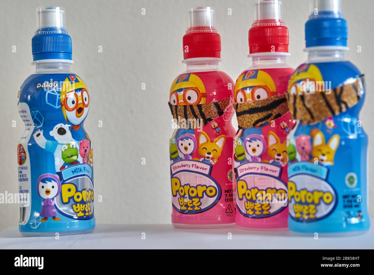 Colourful bottles of Korean flavoured milk, with face masks, concept