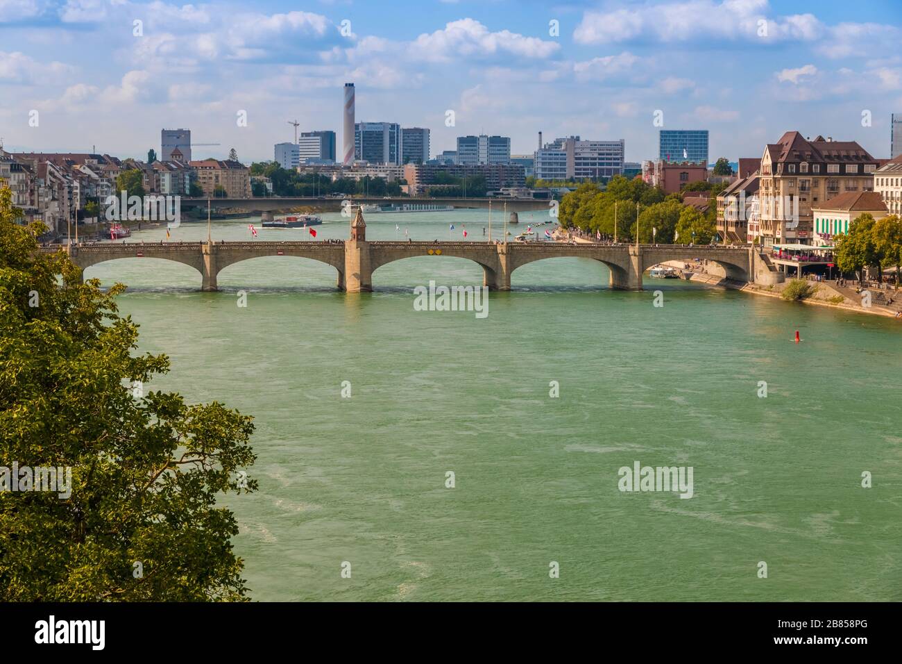 Nice view of the Rhine river with the Middle Rhine Bridge and the industrial area in the background. The bridge connects the main section of Basel... Stock Photo