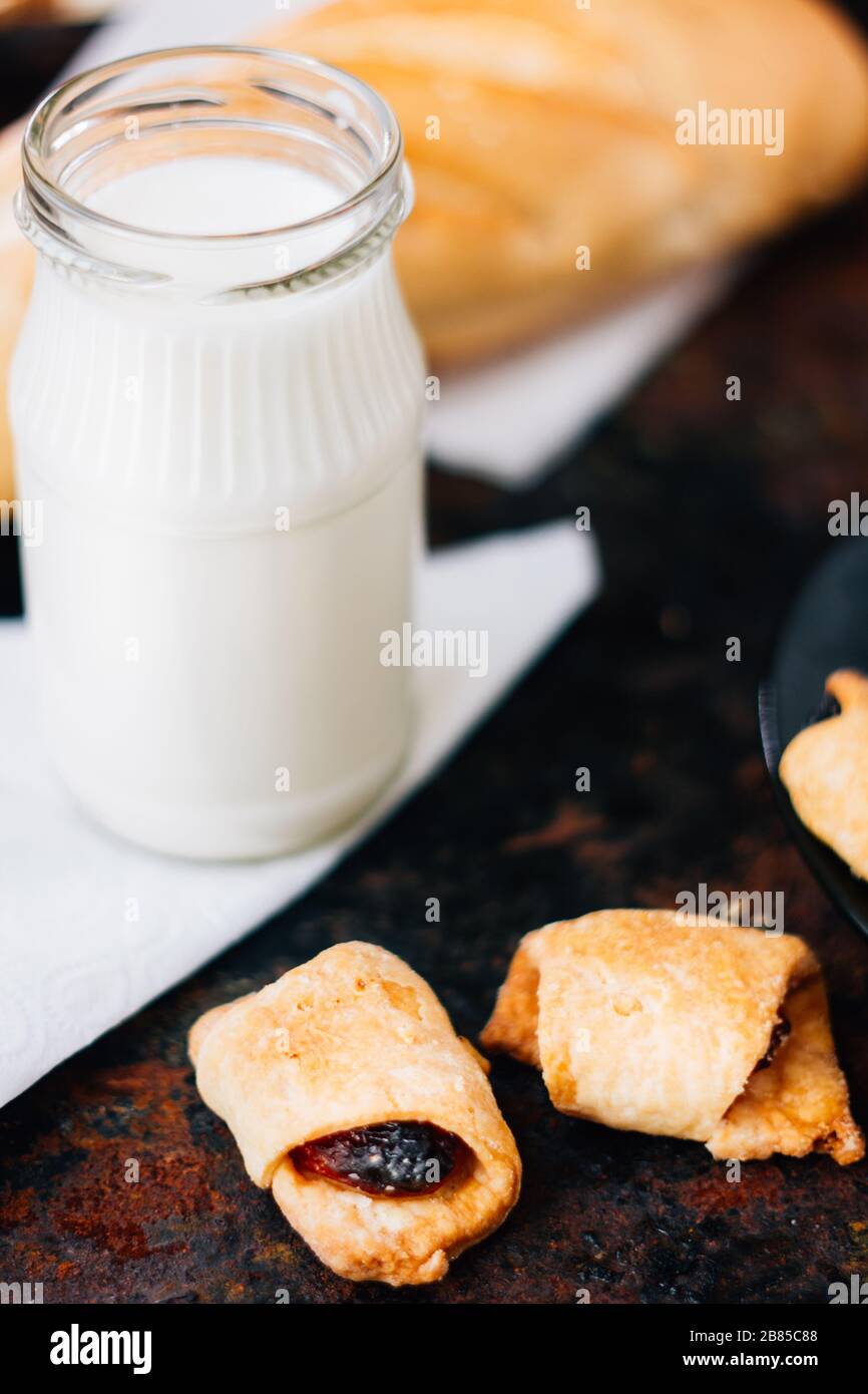 Nice breakfast - milk with croissants on black rustic surface Stock Photo