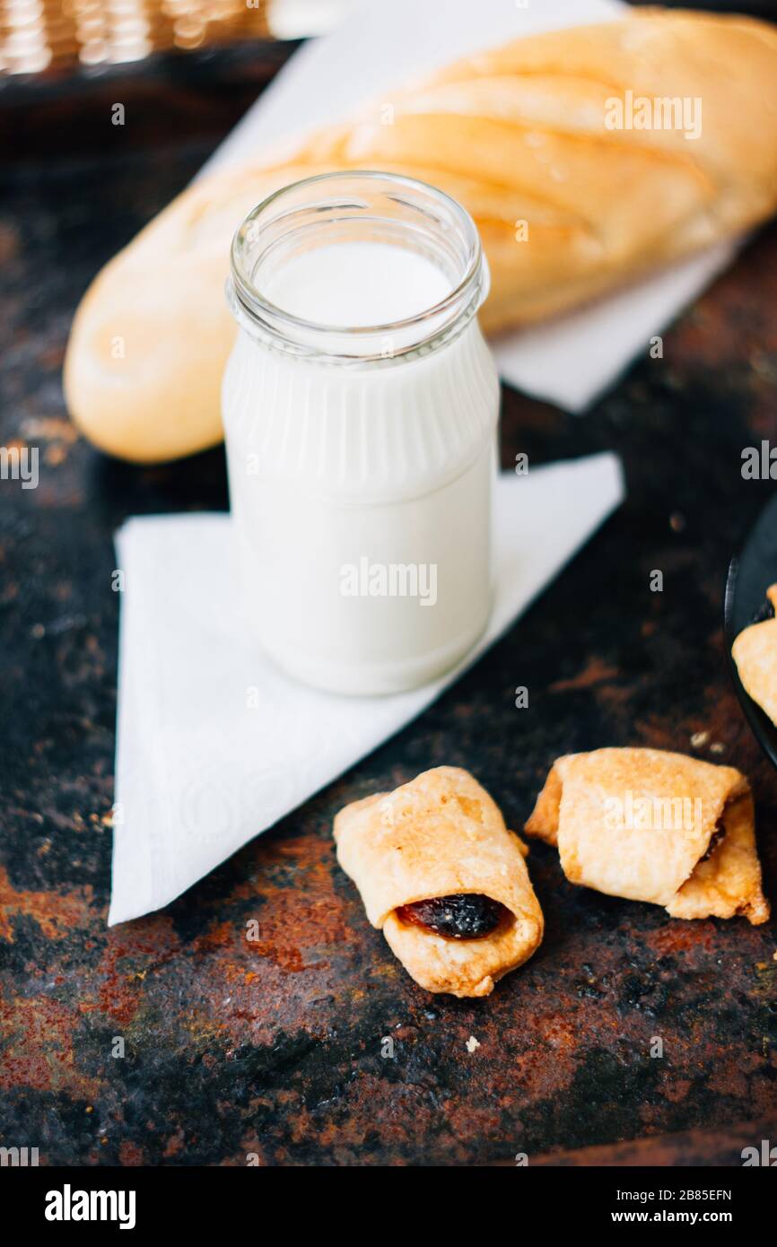 Nice breakfast - milk with croissants on black rustic surface Stock Photo