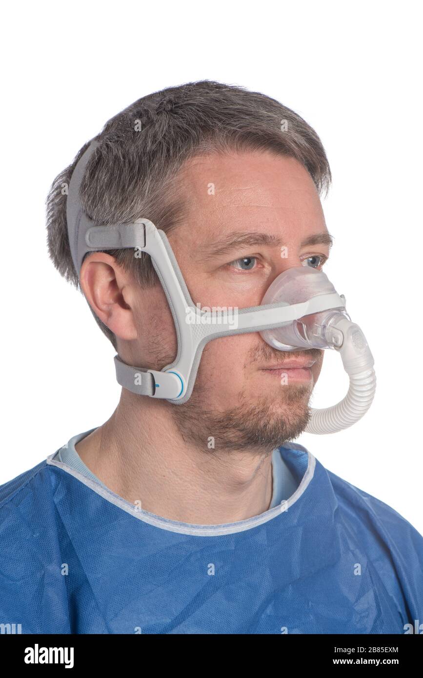 Man wearing CPAP headgear isolated on a white background Stock Photo