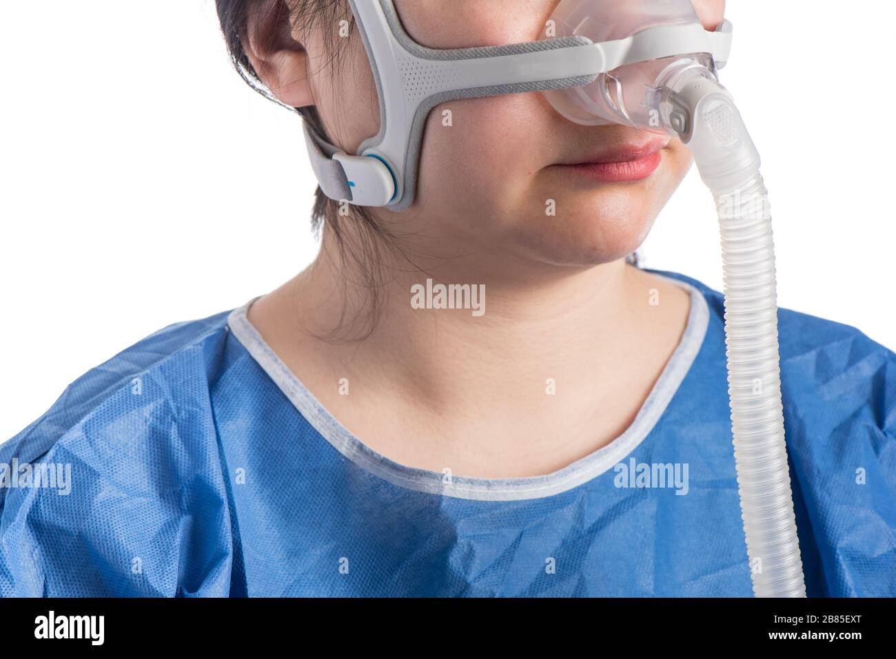 Woman wearing CPAP headgear isolated on a white background Stock Photo