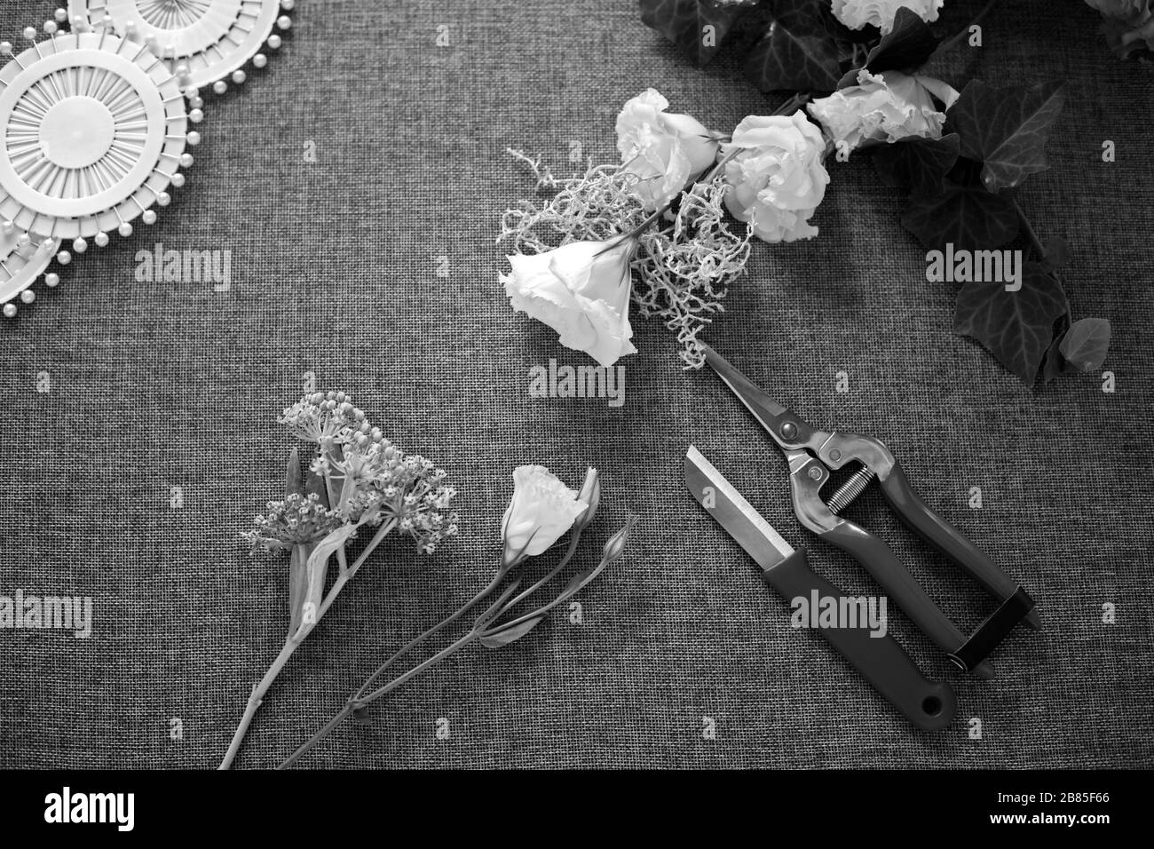 Florist workplace. Tools and accessories. Flowers, pruner, knife, pins Stock Photo