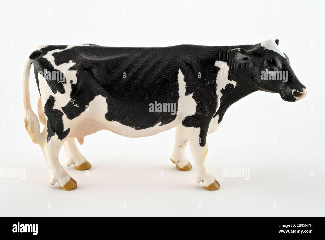 Toy cow isolated on a white background. Black and white spotted rubber or plastic  cow. Farm animals Stock Photo - Alamy
