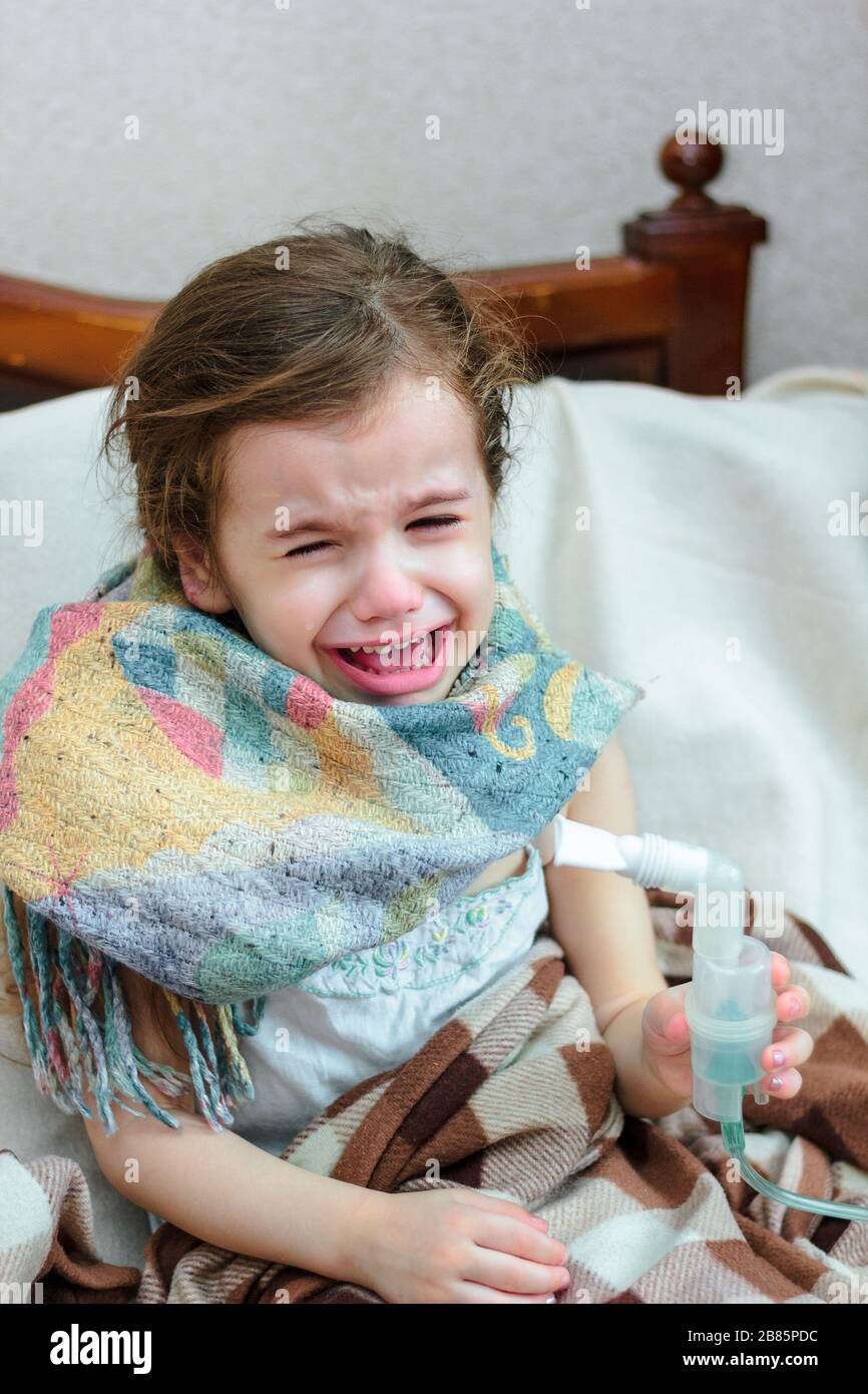 Child with respiratory illness making inhalation with inhaler Stock ...