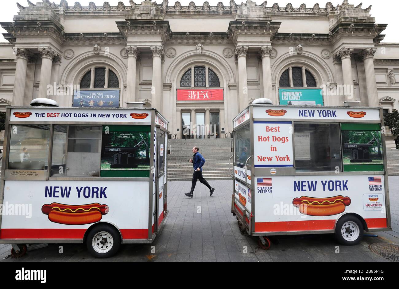 New York, USA. 19th Mar, 2020. A man jogs past the Metropolitan Museum of Art on the 5th Avenue of New York City, the United States, March 19, 2020. The number of COVID-19 cases in the United States topped 13,000 as of 5:30 p.m. (2130 GMT) on Thursday, according to the Center for Systems Science and Engineering (CSSE) at Johns Hopkins University. The fresh figure reached 13,060 with 175 deaths. Credit: Wang Ying/Xinhua/Alamy Live News Stock Photo