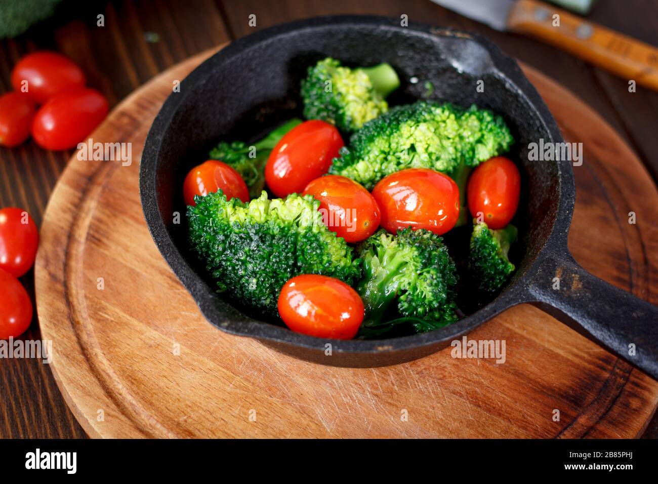 Broccoli cooked with cherry tomatoes inside a frying pan Stock Photo