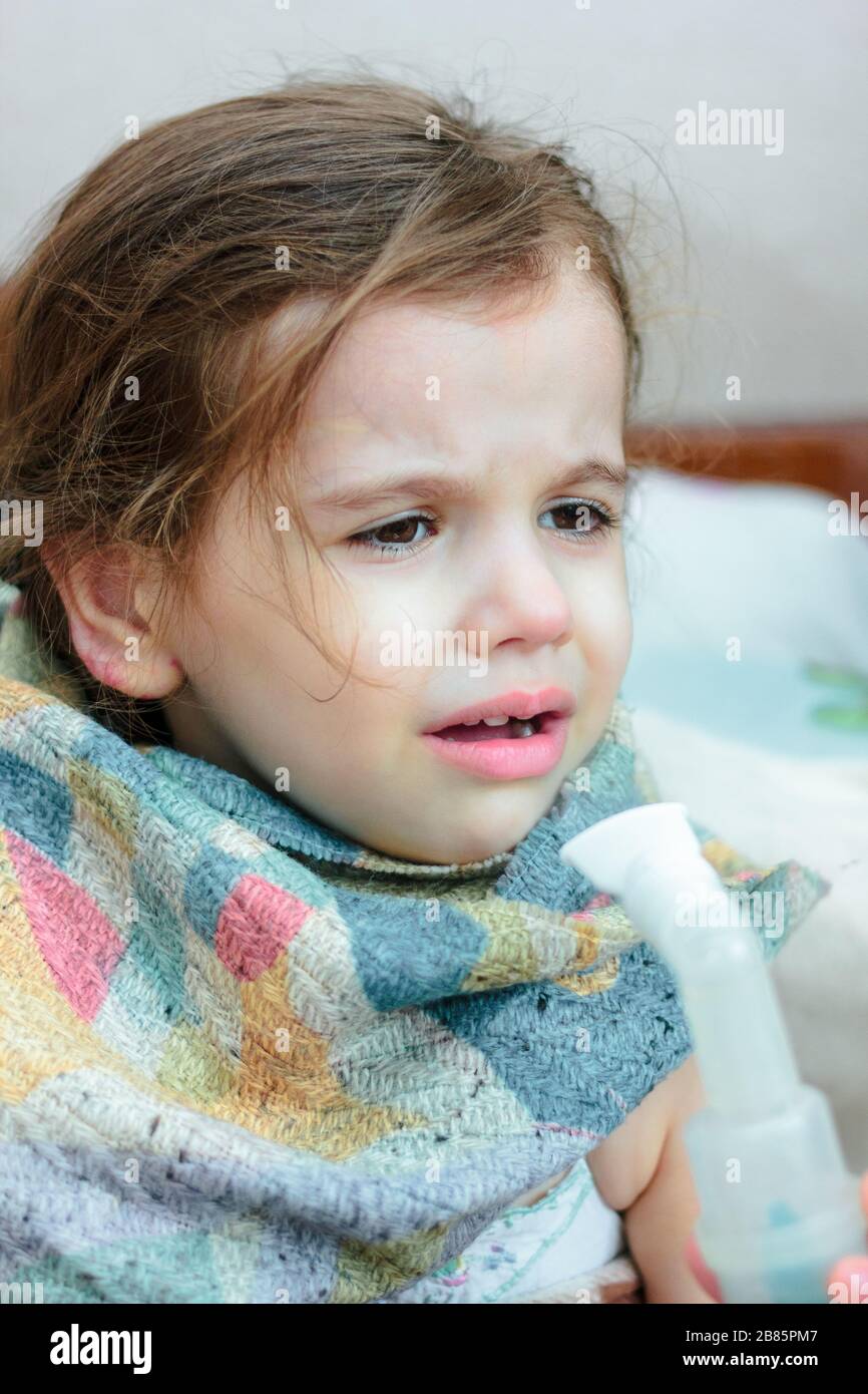 Child with respiratory illness making inhalation with inhaler Stock ...
