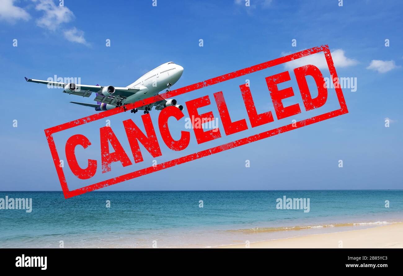 flight cancellation. commercial airplane flight over the sea with red stamp text trip cancelled from city shutdown and border closed, effect from COVI Stock Photo