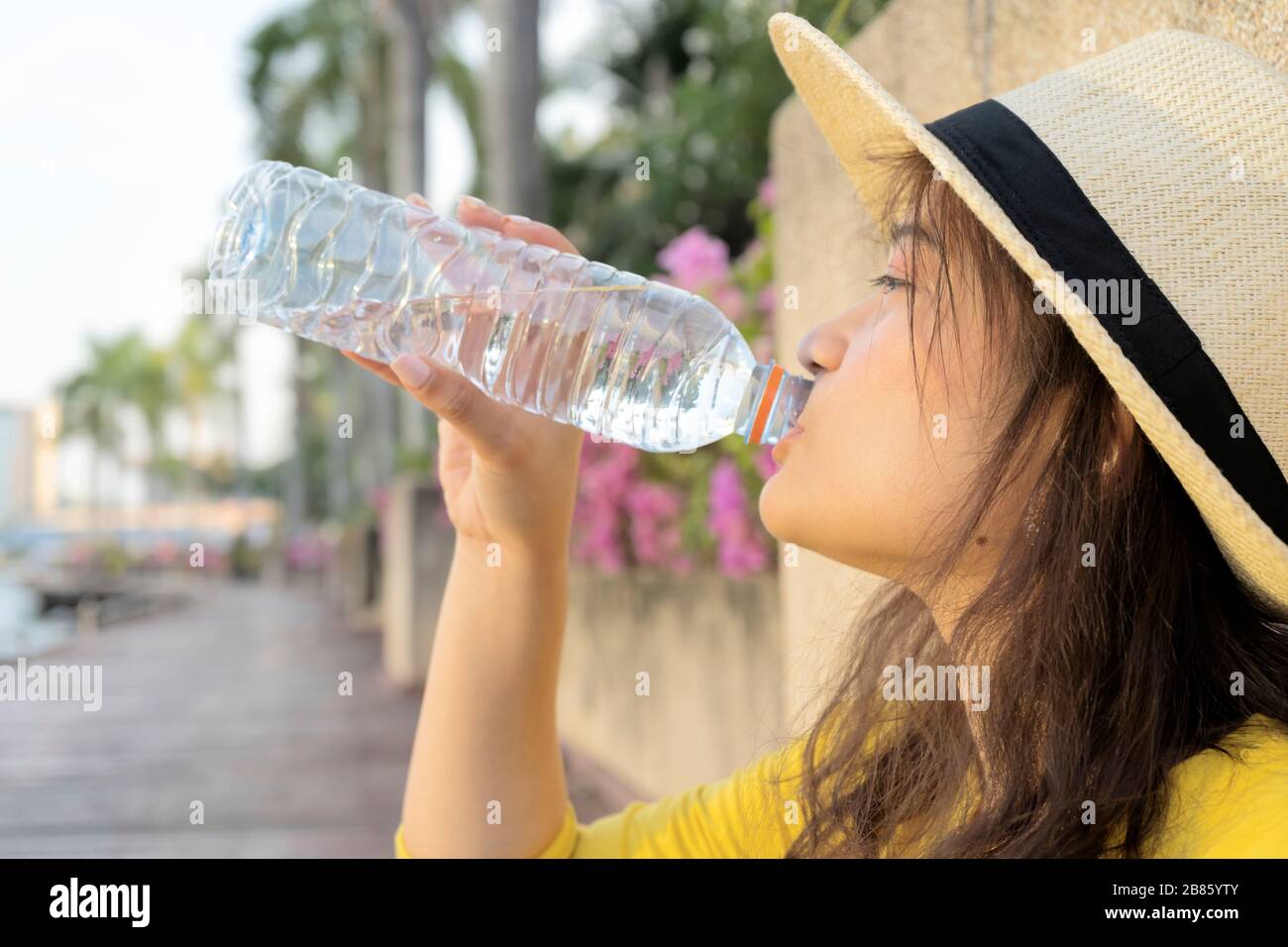 Women who are drinking pure water to keep the body moist. From traveling with fatigue and resting. Stock Photo
