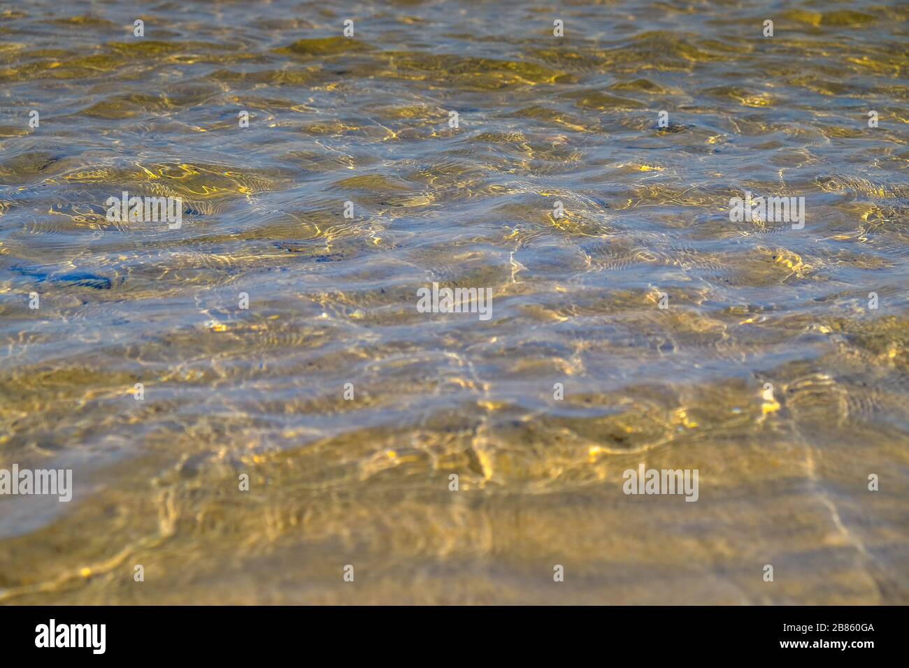 low shot of rippling water over golden sand Stock Photo