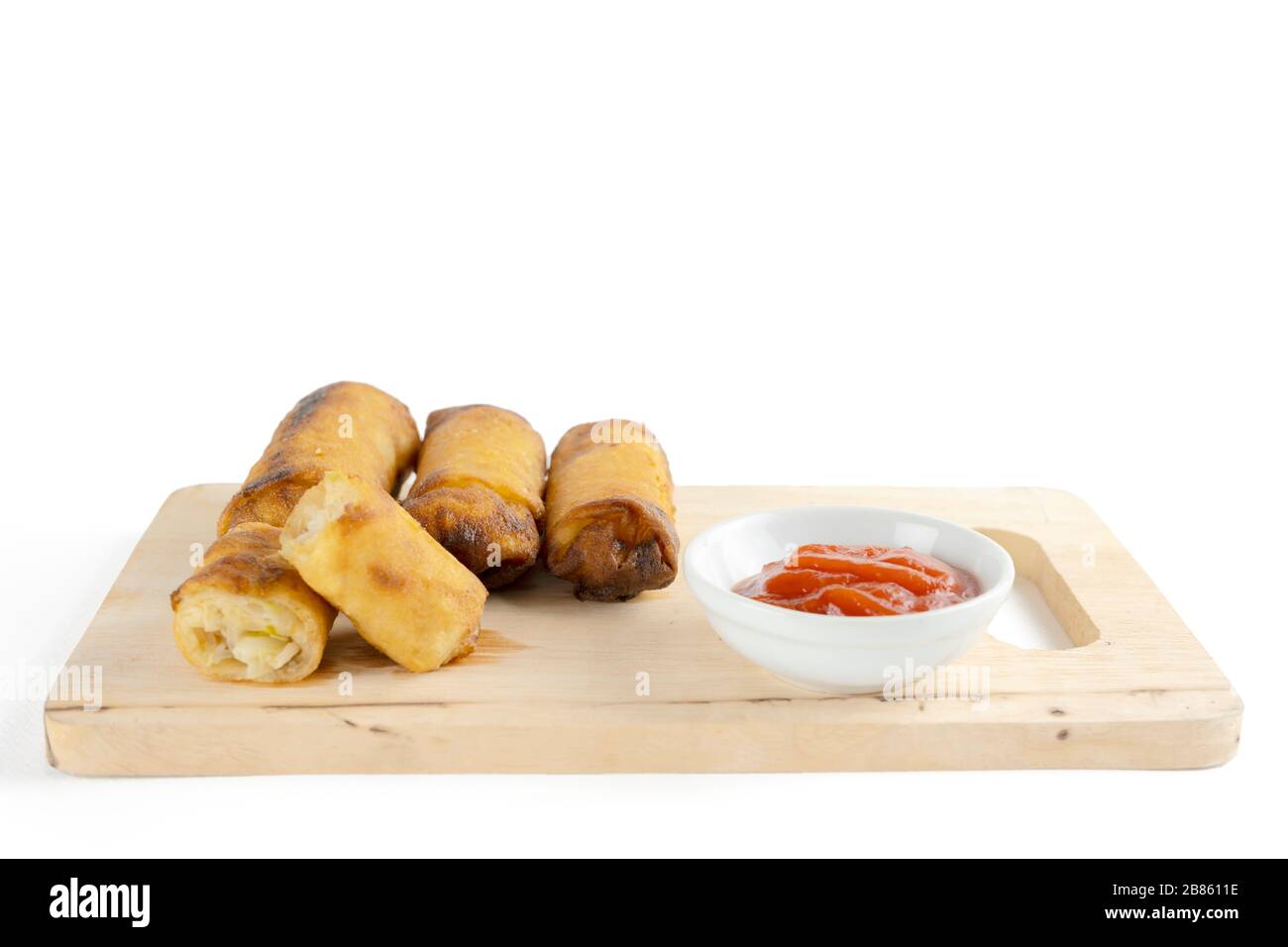 Spring rolls are from Chinese that we have eaten in the Dim Sum menu., ketchup. The original filling is minced pork vermicelli.  on white background. Stock Photo