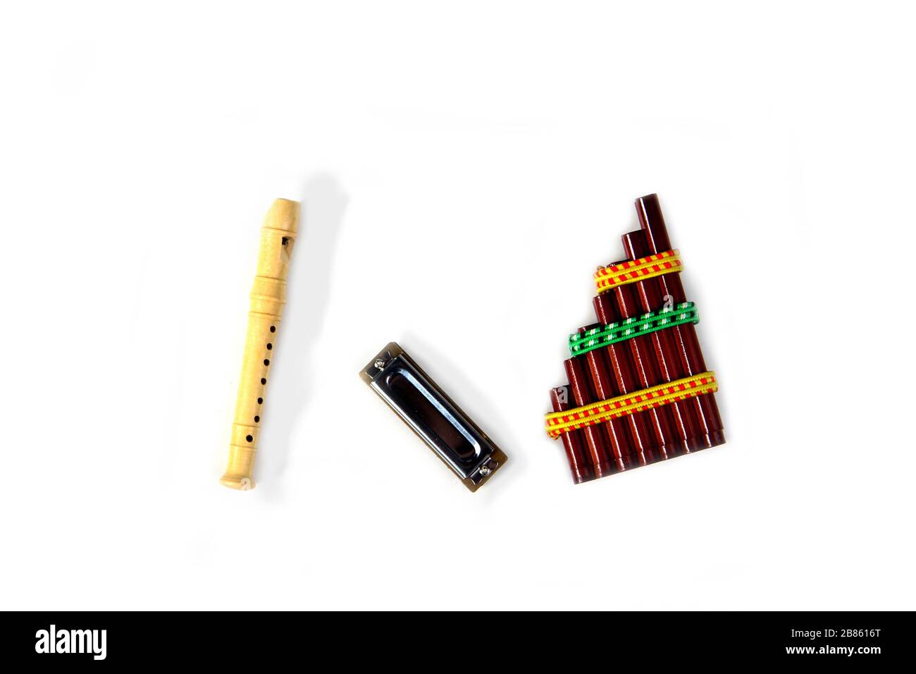 Pan flute, mouth organ and blockflute isolated on white background flat lay. Image contains copy space Stock Photo