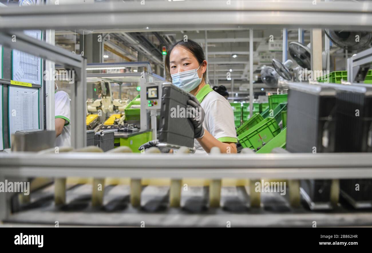 Wuhan, China's Hubei Province. 19th Mar, 2020. Staff members work on a production line at a company in Jingzhou, central China's Hubei Province, March 19, 2020. The Valeo Hubei company has resumed production since late February. Over 90% capacity of the company has recovered and over 80% staff members have returned to their work. Credit: Cheng Min/Xinhua/Alamy Live News Stock Photo