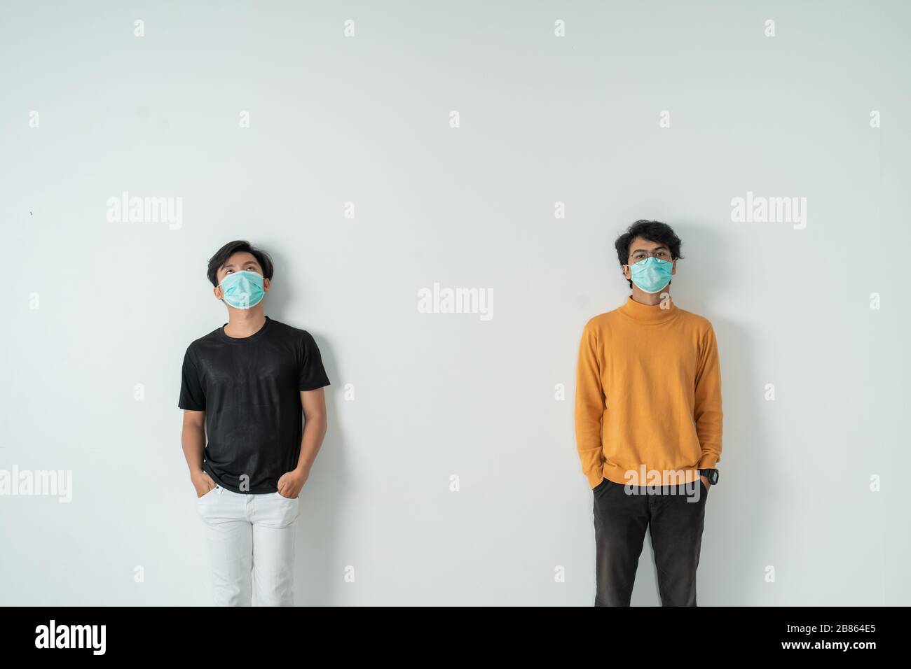 social distancing. people with masks keep their distance during virus ...