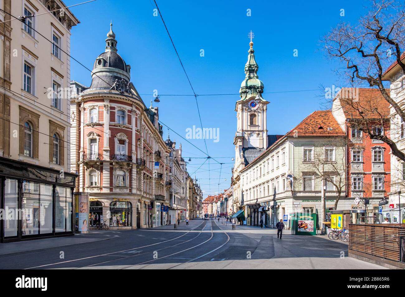 View from Eisernes Tor to street Herrengasse in deserted town Graz, Styria at virus quarantine on spring with the old buildings, Austria Stock Photo