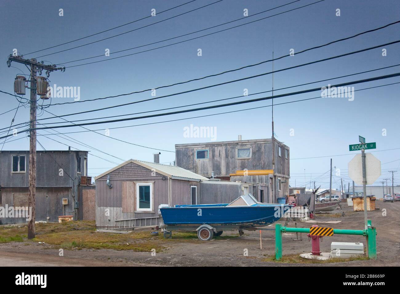 Inuit village with a blue boat and a lamp post at the forefront, Barrow, Alaska Stock Photo