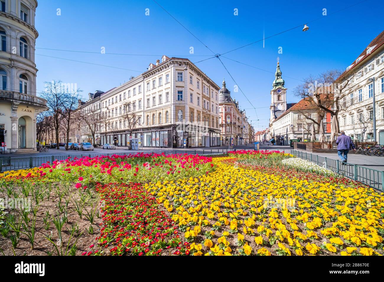 View from Eisernes Tor to street Herrengasse in deserted town Graz, Styria at virus quarantine on spring with beatifull flowers  and the old buildings Stock Photo