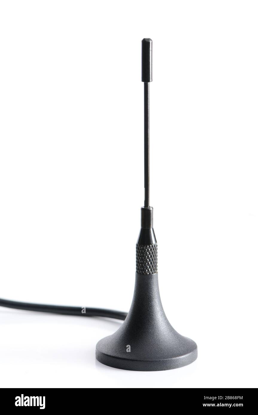 Closeup dark gsm antenna with wires standing on a white table on a