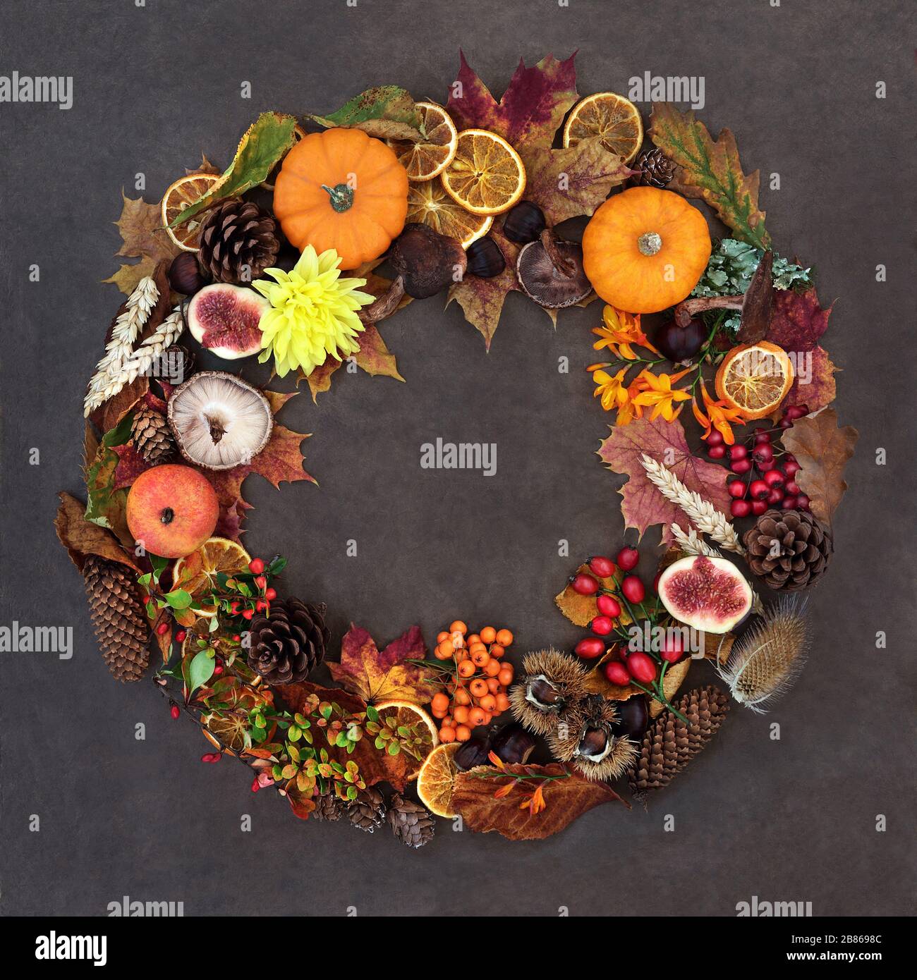 Autumn harvest festival wreath composition with a variety of natural flora, fauna and food on lokta  background. Stock Photo