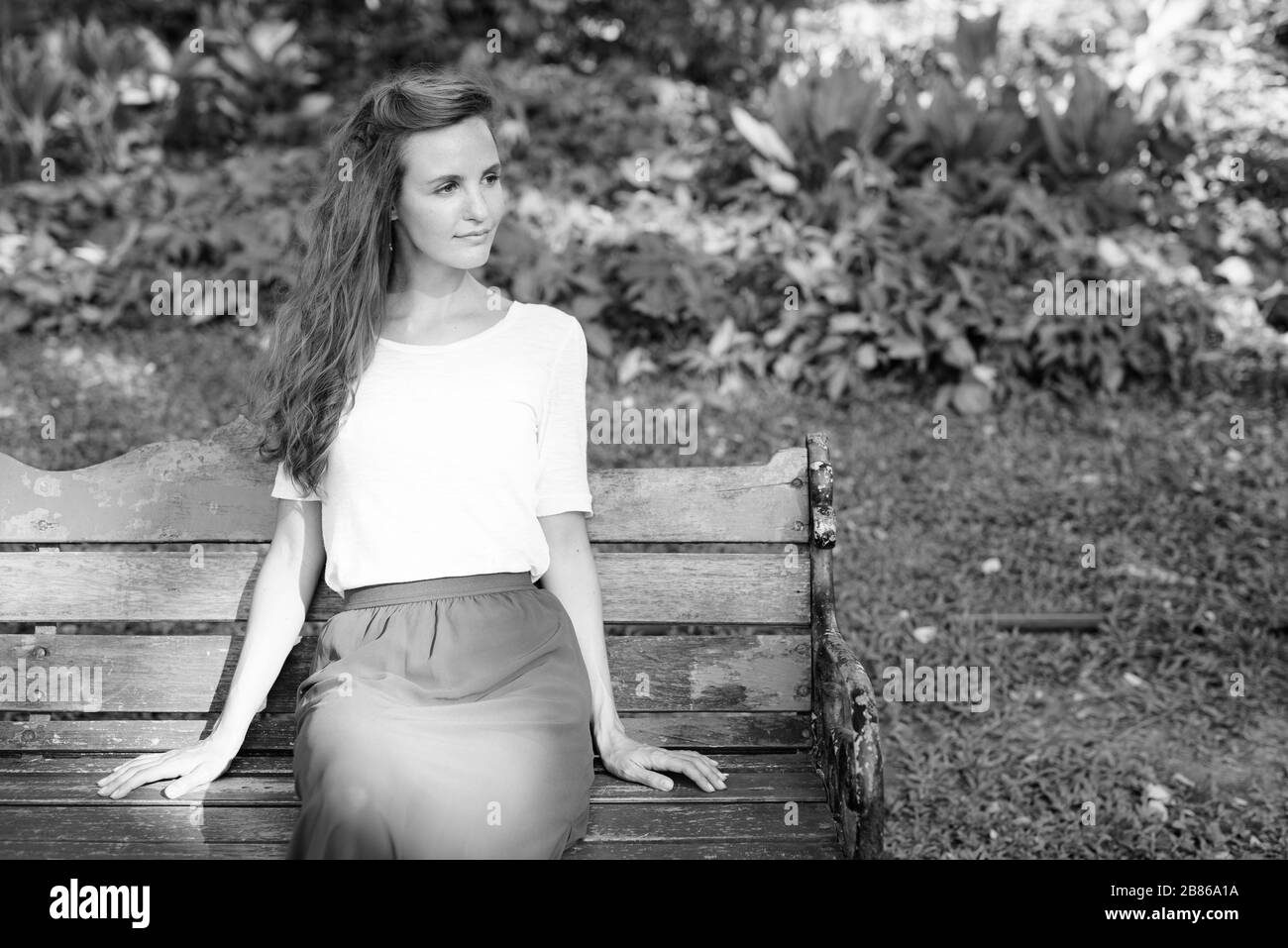 Portrait of beautiful woman relaxing at the park Stock Photo - Alamy
