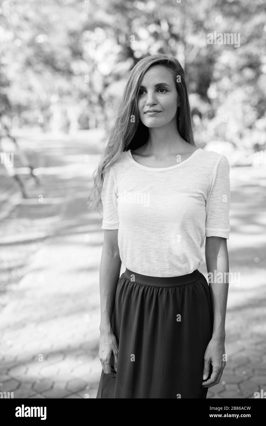 Portrait of beautiful woman relaxing at the park Stock Photo - Alamy