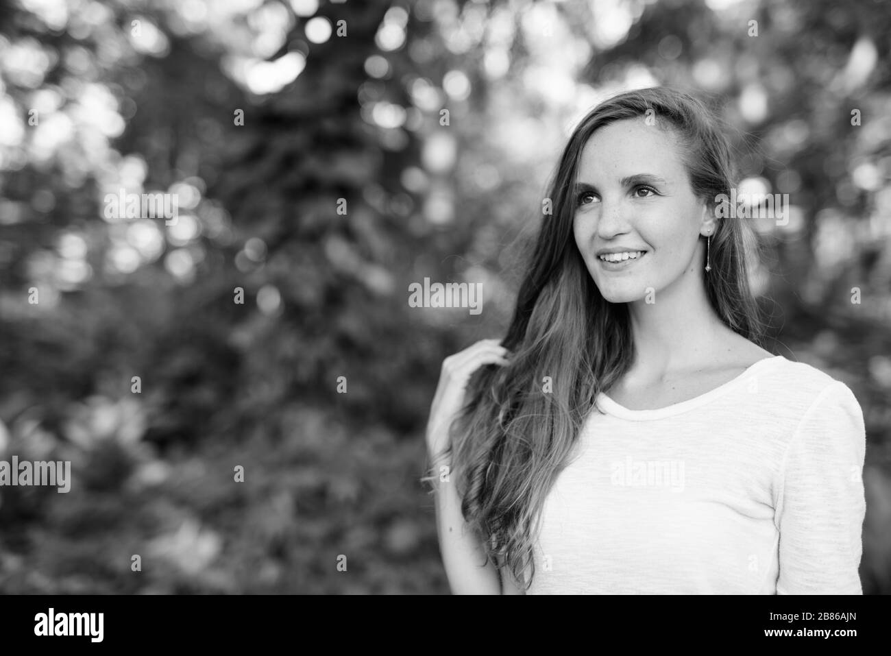 Portrait of beautiful woman relaxing at the park Stock Photo - Alamy