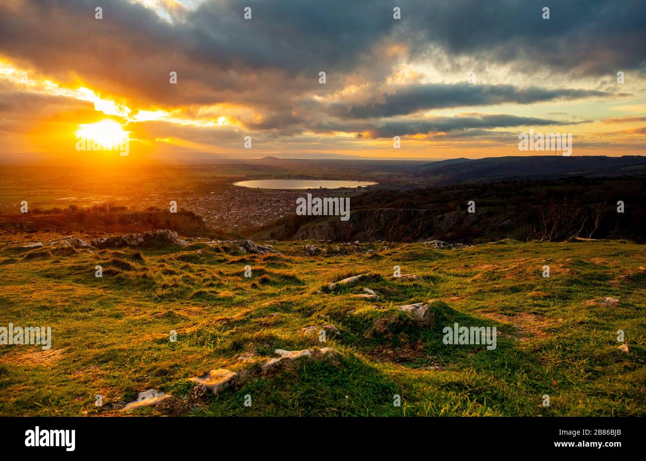 The sun sets across the Somerset levels, taken from the top of Cheddar Gorge. UK, England. Stock Photo