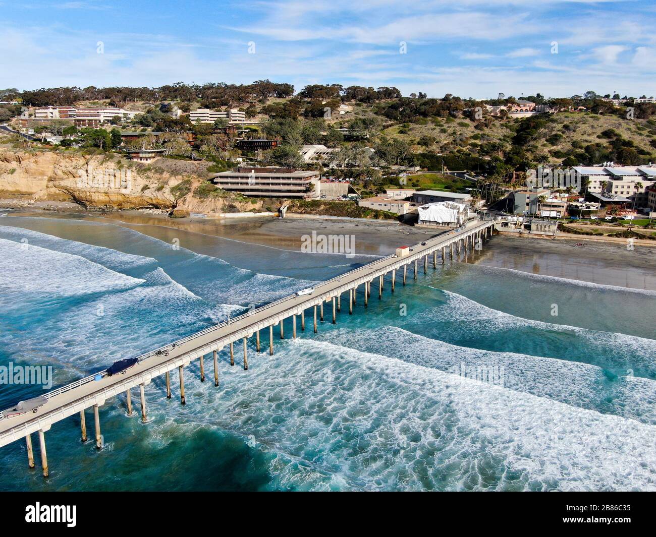 Aerial view of the scripps pier institute of oceanography, La Jolla, San Diego, California, USA. Research pier used to study ocean conditions and marine biology. Pier with luxury villa on the coast. Stock Photo