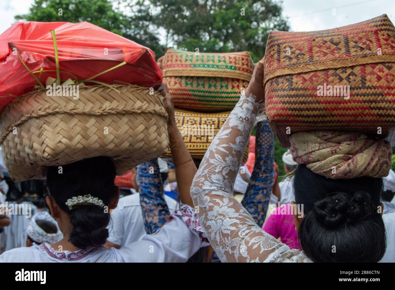 Indonesian women with basket over the head during the holy Celebration at Besakih temple. Bali, Indonesia Stock Photo