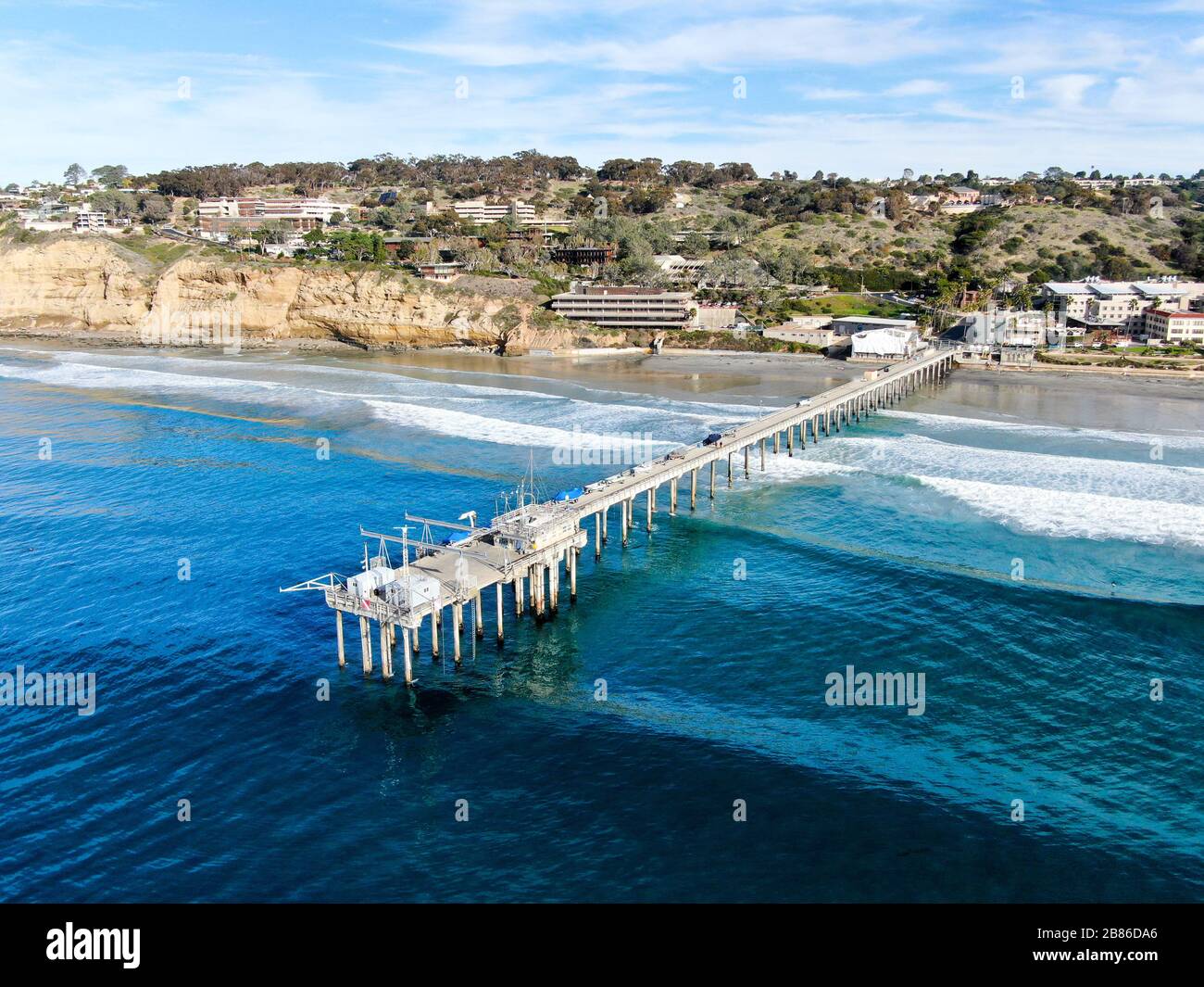 Aerial view of the scripps pier institute of oceanography, La Jolla, San Diego, California, USA. Research pier used to study ocean conditions and marine biology. Pier with luxury villa on the coast. Stock Photo