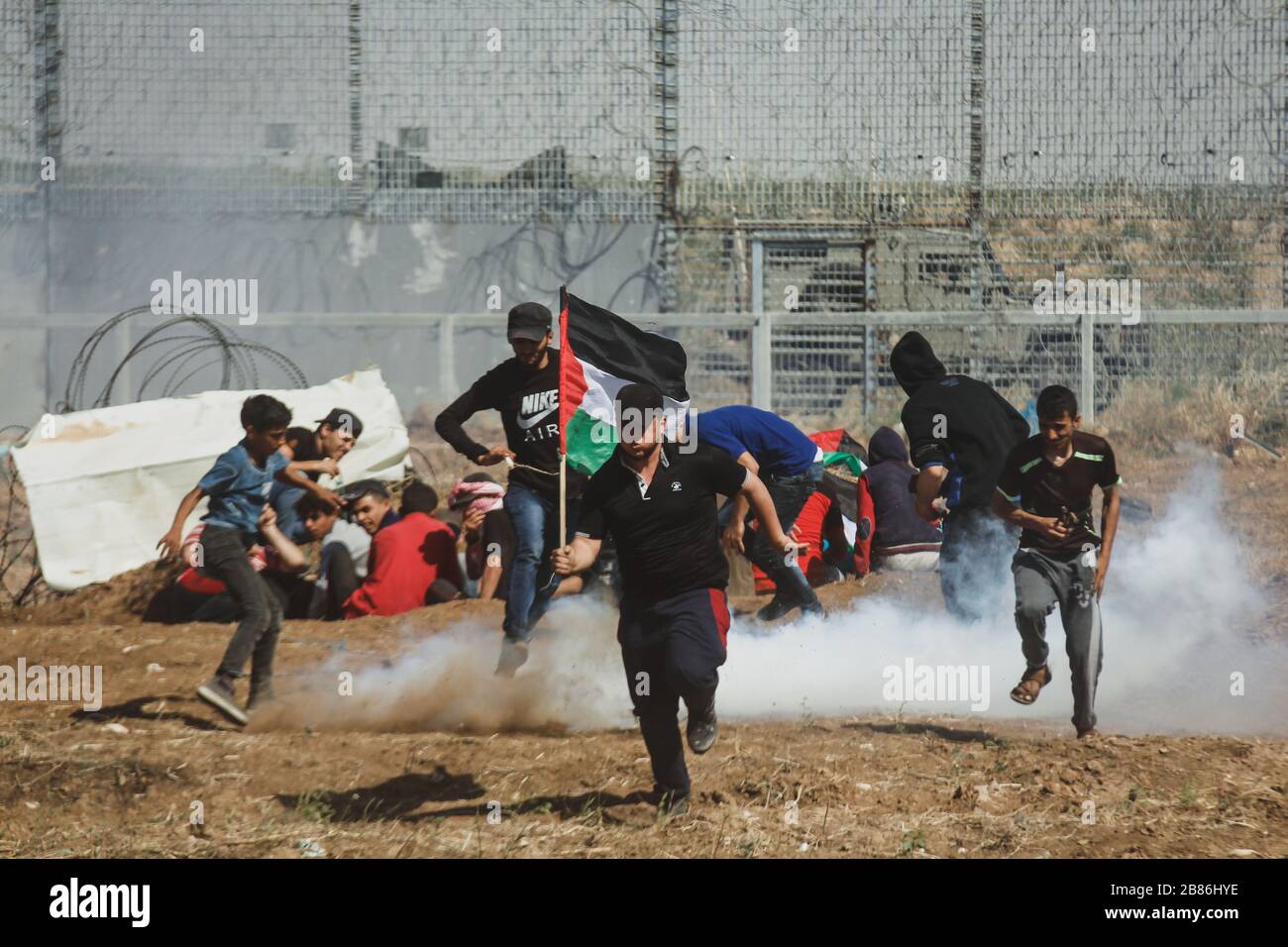 Israeli forces use tear gas to disperse Palestinian protesters during the 'Great March of Return' at the Israeil-Gaza border, on May15, 2019 Stock Photo