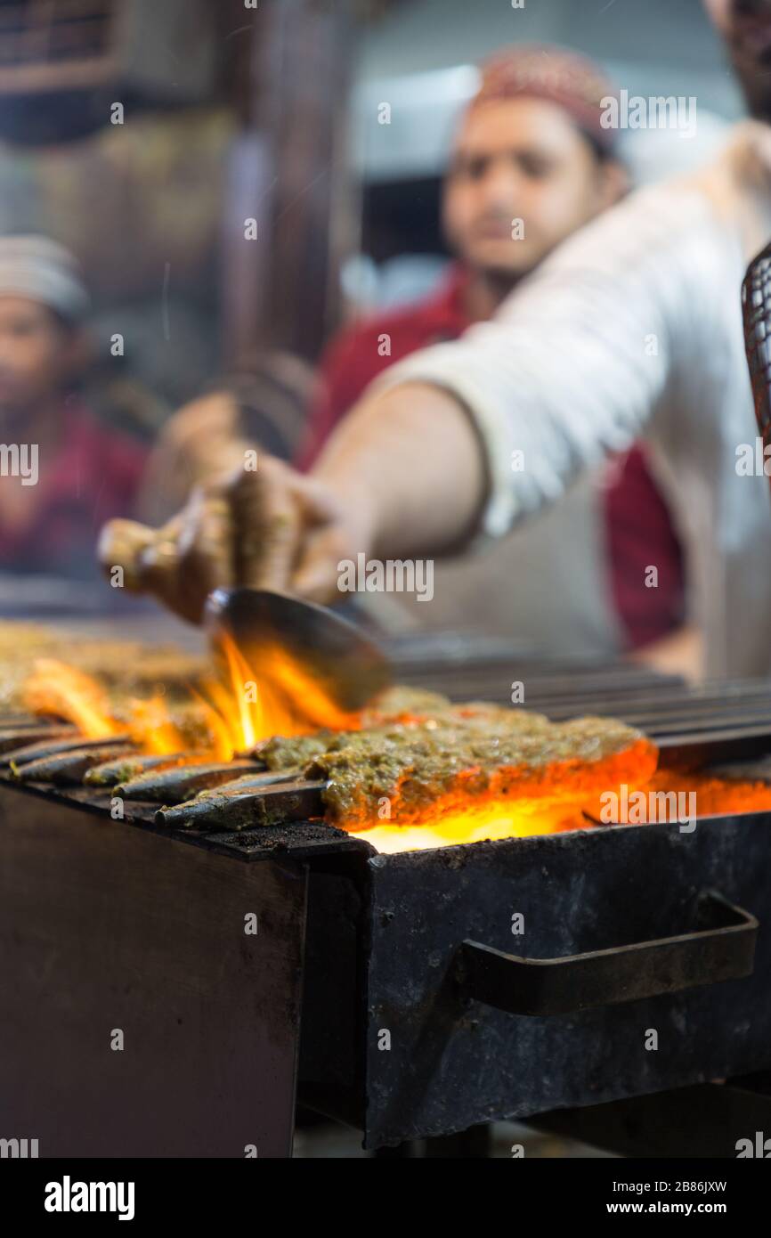 New Delhi, India - May 31, 2019: Cooking meat kebabs at Jama Masjid in Old Delhi India Stock Photo