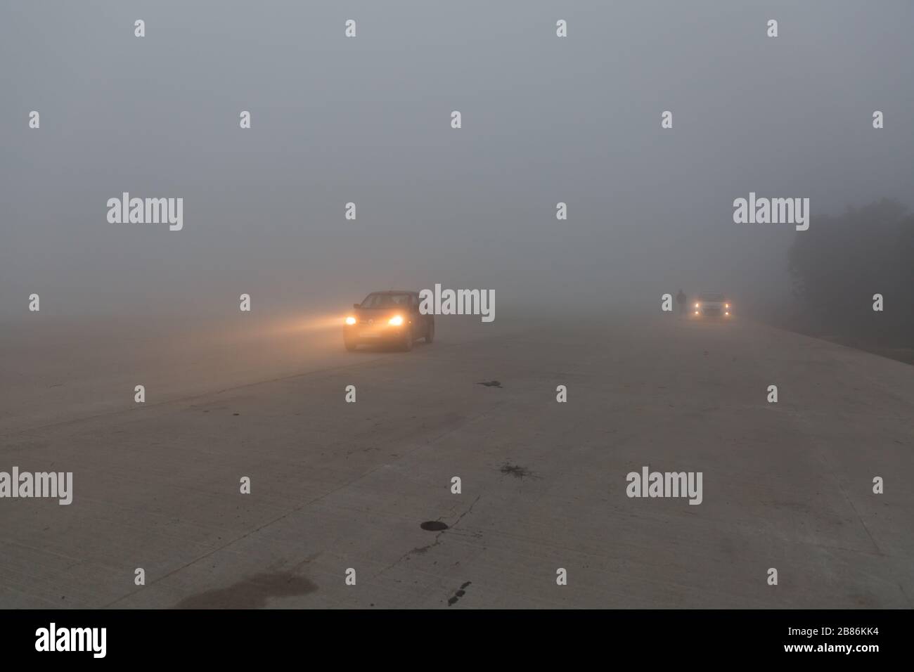 Cars on foggy highway in India Stock Photo