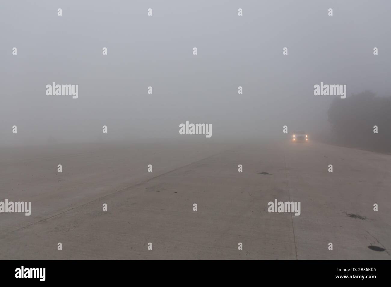 headlights on foggy highway india Stock Photo