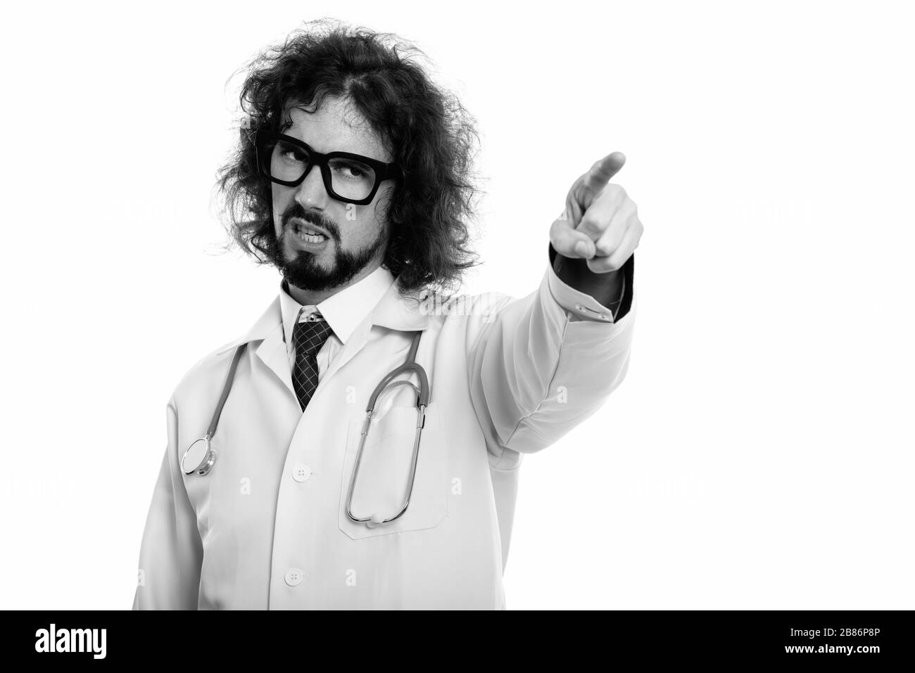 Studio shot of angry man doctor pointing finger at distance Stock Photo