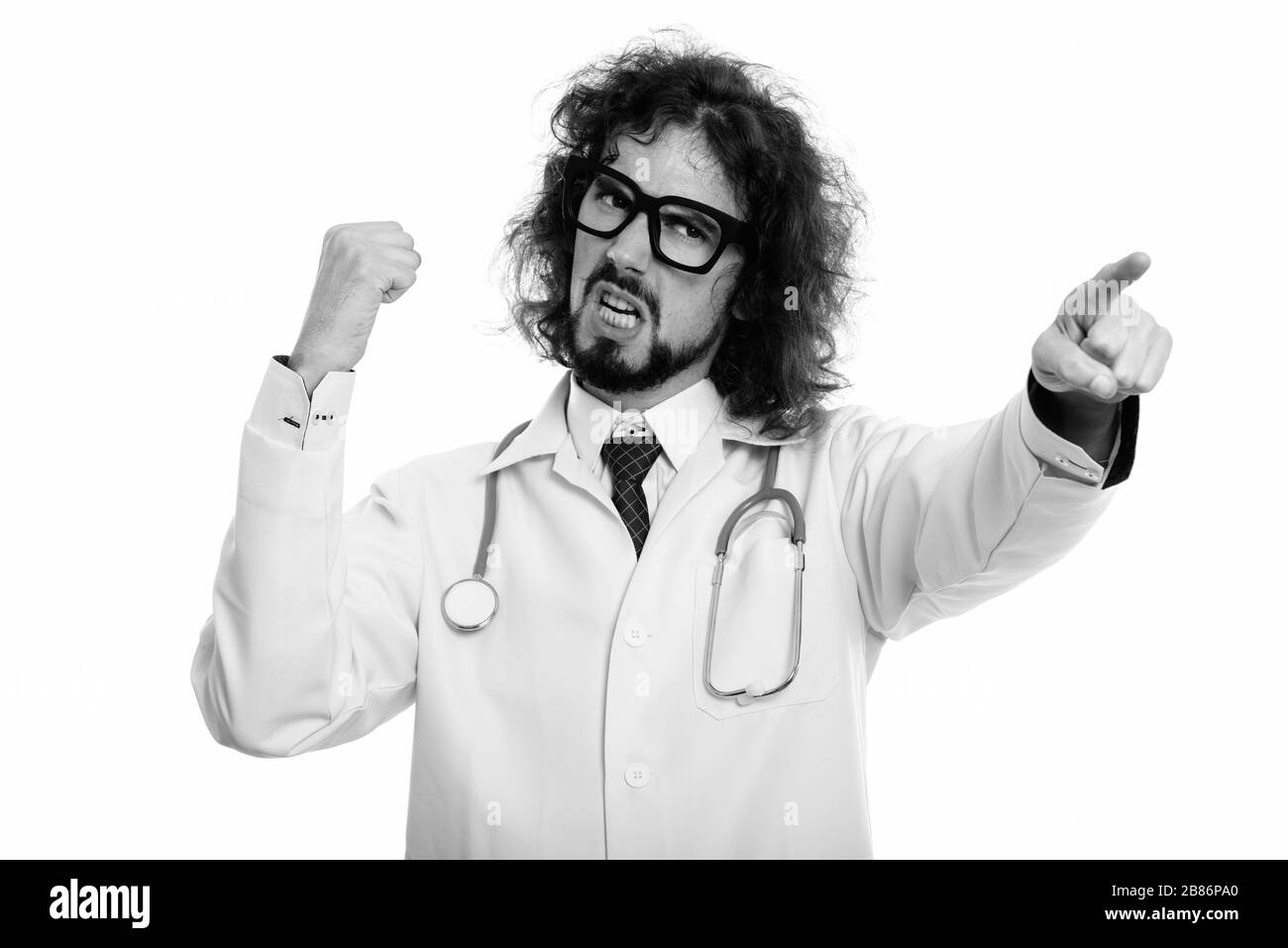 Angry man doctor pointing finger at distance with fist raised Stock Photo