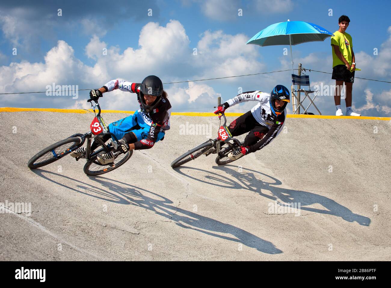 Two athletes in action during a cruiser bike race. Competition concept. The last sprint. Stock Photo
