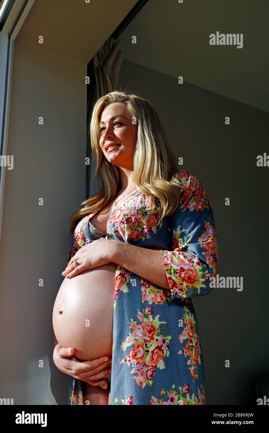 woman nine months pregnant in sunshine Stock Photo