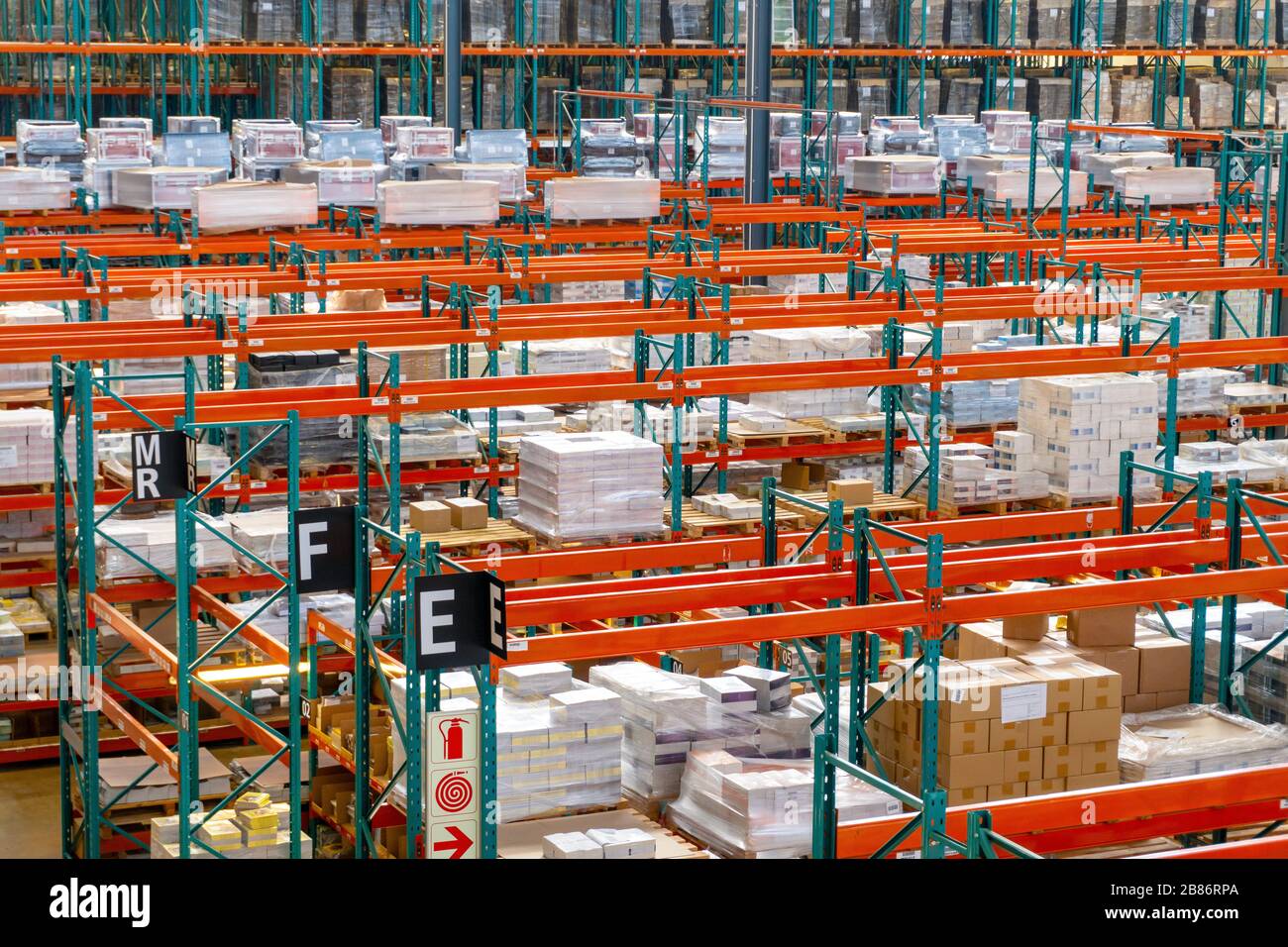 Big warehouse with red racks full of boxes waiting for shipment Stock Photo