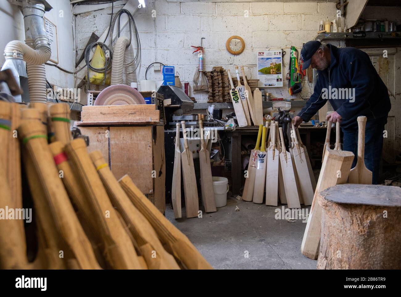 Batmaker Tony Sains crafts a handmade cricket bat at a workshop at Warsop Stebbing in East Hanningfield, Essex. With the start of the season just weeks away, the ECB, the governing body of cricket have recommend that all forms of recreational cricket are for now suspended. Stock Photo