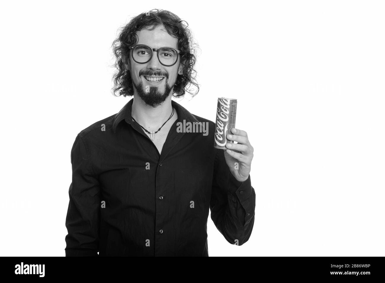 Happy handsome Caucasian man holding Coca-cola can Stock Photo