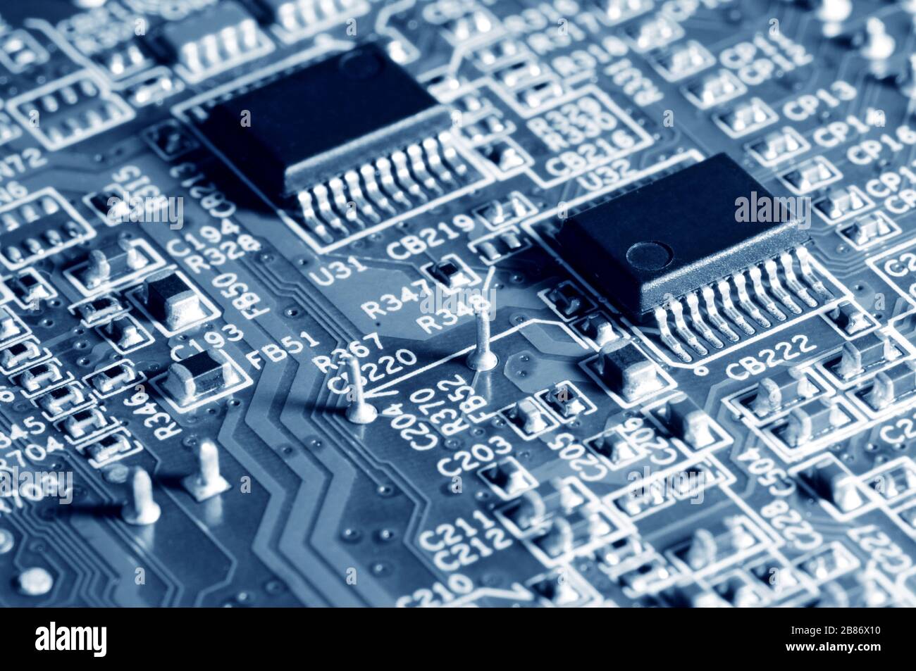 Close-up electronic circuit board with micro chips from a home appliance or laptop electronics and complex devices. Concept of microchips and future t Stock Photo