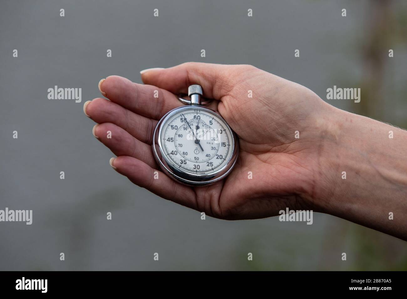 womans hand with stop watch Stock Photo