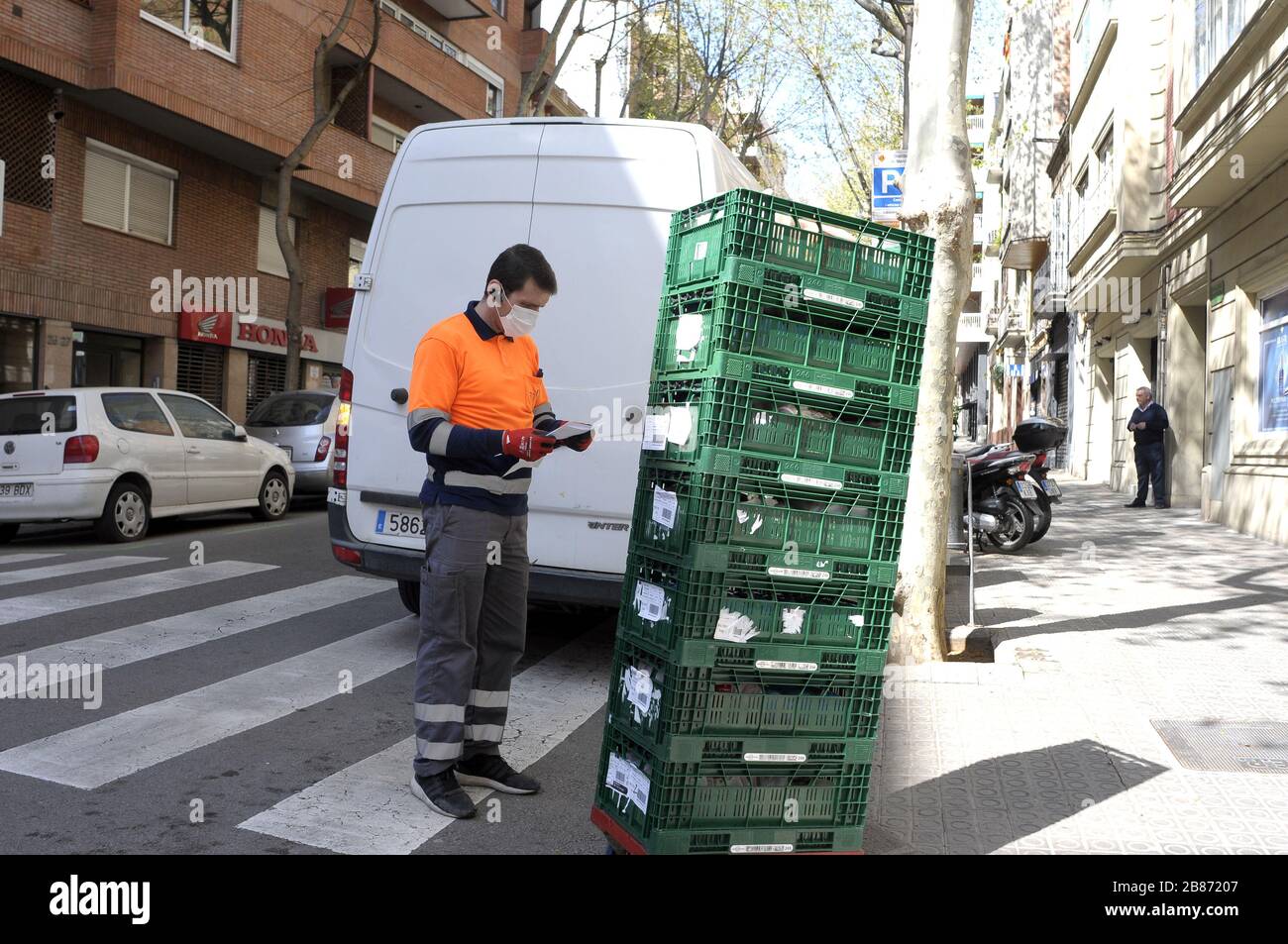 home delivery of basic food products during the state of alarm in Barcelona where citizens remain in confinement as a prevention of the risk of co Stock Photo